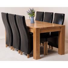 This stunning oak finish dining table would make a great addition to your home. Kuba Oak Dining Set 180cm 6 Black Chairs