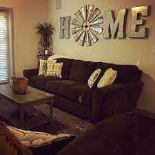 The area has a piano on the side and has a large fireplace. How To Make An Interesting Art Piece Using Tree Branches Ehow Home Living Room Western Living Room Living Room Decor Country