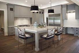 Expansive Gray Kitchen Showcases A Stunning Large Square Center Island Fitted With Legs Kitchen Island Quartz Top White Quartz Countertop Kitchen Island Quartz