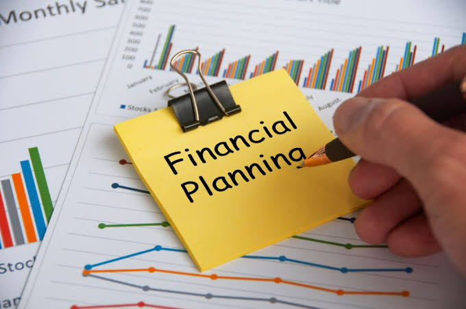 A professional financial consultant from Pillar Talent Consulting meeting with business executives in a modern office, reviewing financial reports, tax documents, and growth charts on a laptop. The scene represents tax and advisory, taxation advisory services, and strategic money planning for long-term business success.