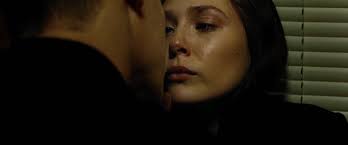 People who find themselves inexplicably imprisoned, particularly for a crime they didn't commit, often leads them to ponder their life choices, and how they ended up on the fringe of society. Blu Ray Movie Screencaps 01517 Elizabeth Olsen Source Photo Archive