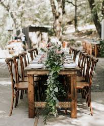 Rustic Wood Farm Tables Dark Wood X Back Bistro Chairs Gorgeous Green Garland Centerpieces Photoby Lillywhite Farm Table Bistro Chairs Table
