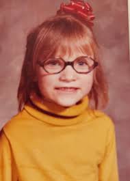 I love the bows my mom put in my hair. She said Smile for the picture. 1972