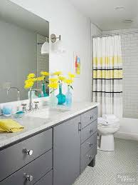 An All White Bathroom Gets An Energy Boost With Accents Of Yellow And Gray Yellow Accents Sit Best Bathroom Colors Bathroom Color Schemes Yellow Grey Bathroom