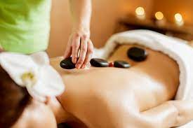 Young Woman Having A Hot Stone Massage Therapy Paid Ad Ad Hot Therapy Massage Woman Stone Massage Hot Stone Massage Massage Therapy