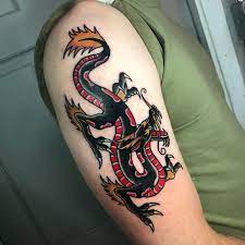 The movement in this black and white dragon tattoo makes the creature appear to be floating. Traditional Dragon By Jerry At Seven Swords Asheville Tattoo