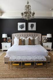 Chic décor (black, white, and gray) saved by amber flowers. Decorating With Fashionably Chic Black And White Spots Homeandeventstyling Com Home Bedroom Glam Master Bedroom Bedroom Design