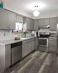 A Grayscale Kitchen Palette Lets The Style Shine Through Cabinet Refacing In Our Suede Gray S Hardwood Floors In Kitchen Kitchen Remodel Kitchen Remodel Small