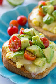 Cheesy Scrambled Egg Toast With Avocado Cherry Tomato Medley Breakfast Avocado Breakfast Avocado Toast