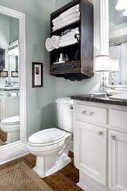 White vanity unit basin sink toilet bathroom cabinets combined with water tank. How To Reinvent Your Bathroom With Over The Toilet Shelves