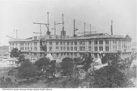 The capitol building in austin, texas with colorful flower beds in the foreground, lit up by street. Construction Of The Capitol Building The Portal To Texas History
