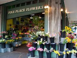 The crew gives them a fresh cut, nets them and ties the tree to your car! Pike Place Flowers Seattle Shopping Districts Seattle Washington World Travel Shop Shopping Guides For Travel Destinations Around The World