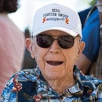 Retired Brig. Gen. Chuck Yeager receives words of