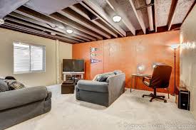 By adding a bar, some nice leather furniture, and an entertainment center, you can make it a cool spot to hang out with company. Fantastic Partially Finished Basement With Painted Ceiling Basement Ceiling Ideas Cheap Painted Ceiling Basement Ceiling