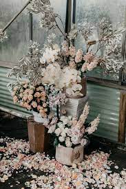 There are few things better than bright flowers in the spring to reassure you that winter has passed and warmer days are here. Spring Wedding Inspiration With These Urns Full Of Overflowing Flowers These Pink And White Ro In 2020 Wedding Flower Arrangements Wedding Flowers Flower Arrangements