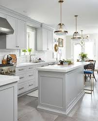 New kitchens design trends 2020 2021 colors materials ideas. Framed By Gray Staggered Floor Tiles Accented With A Gray And White Runner A Li White Kitchen Design Kitchen Design Kitchen Remodel