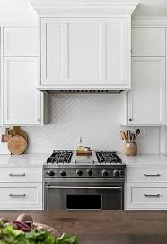 A white backsplash complimented the black and red accents in this kitchen. Herringbone Tile Ideas Backsplash Kitchen Backsplash Trends Kitchen Inspirations White Kitchen Backsplash