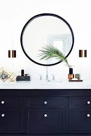 This Navy Blue Bathroom Vanity And White Marble Counter Top Is Accentuated With A Steel Framed Roun Round Mirror Bathroom White Bathroom Designs Painted Vanity