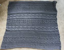 This cable knit afghan would fit into a celtic home decor and makes a wonderful housewarming gift. Knitting Project 5 15 Grey Cable Knit Blanket Snapshots Whatnots