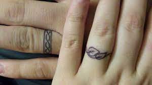 44 Wedding Ring Tattoos With Diversifying And Creative Meanings Tattooswin Ring Tattoo Designs Wedding Band Tattoo Toe Ring Tattoos
