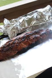 Showing how to bake pork tenderloin in the oven with foil by adding butter to top of pork tenderloin. Grilled Whole Pork Loin