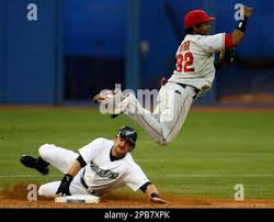 Los Angeles Angels shortstop Eric Aybar, right, forces out Toronto Blue  Jays' Gregg Zaun at second base and tries to turn the double play to first  during fourth inning baseball action on