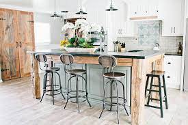 The kitchen island and the peninsula have the same wooden hue that complements the hardwood flooring. Vintage Metal Kitchen Island Stools Design Ideas