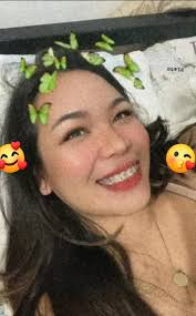 Yorkshire terrier holding owner's hand for treats