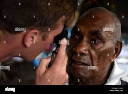 U.S. Air Force Capt. Eric Noll, an optometrist with the 354th Medical  Group, Eielson Air Force Base, Alaska, checks a patient's eyesight at Tata  Primary and Secondary School during Pacific Angel 18-3
