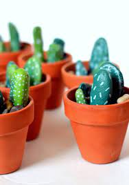 For our 3d paper cactus centerpieces, we chose asymmetrical terra cotta pots that we covered in a quick coat of orange spray paint to complement our tablescape. Easy To Make Painted Rock Cactus Centerpieces