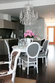 Romantic Dining Room With Black And White Striped Chairs Chandelier And A Pretty Pink Bouquet Eclectic Dining Room Dining Room Design Pedestal Dining Table