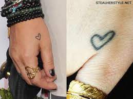 Sometimes the realistic heart tattoo is held in a human hand, either yours or someone else's. Brandi Cyrus Tattoos Meanings Steal Her Style