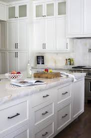 white kitchen cabinets with brass knobs