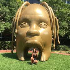 There's a huge gold Travis Scott head outside Cactus Music