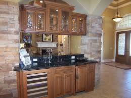 Hickory Cabinets With Doublesided Glass Doors Floating Between Stone Columns Make A Great Room Divider With Less Hickory Cabinets Great Rooms Kitchen Cabinets