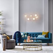 This sofa includes a tufted back and classically colored blue and pale pinkish grey velvet upholstery with contrasting clear metal legs that create a sofa that makes a lasting. Bradford Sofa