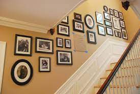 I found this helpful info on arranging prints on www.wholesaleframing.com place larger frames in the centre to creat a focal point, create a gallery by surrounding them with smaller frames. Photo Wall Stair Wall Photo Wall Staircase Pictures