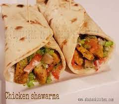 Shawarma Is A Middle Eastern Dish Of Meat Cooked On A Rotisserie Sliced And Served With Pita Bread Chicken Shawarma Wrap Shawarma Ingredients Chicken Shawarma