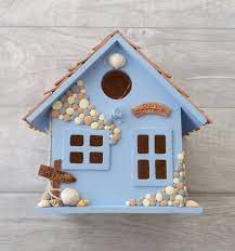 Immerse yourself in the beach life with this figurine. Sunflower And Ladybird Illuminated Bird House Ornament Garden Etsy Decorative Bird Houses Bird House Wooden Bird Houses