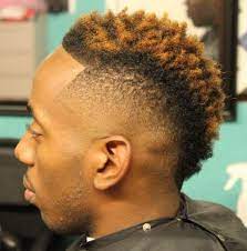 The mohawk (also referred to as a mohican) is a hairstyle in which, in the most common variety, both sides of the head are shaven, leaving a strip of noticeably longer hair in the center. 20 Creative Mohawks For Black Men