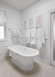 If you are tiling or wainscoting your walls, you may need to adjust the height so. Art Above Towel Bar Design Ideas
