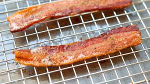 Lay bacon slices in a single layer directly on a baking sheet or on a rack, making sure to not overlap. How To Bake Bacon Perfectly Every Time