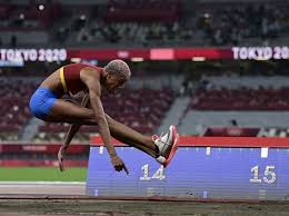 The competitor runs down the track and performs a hop, a bound and then a jump into the sand pit. 591lm46viuoscm
