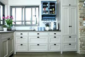 The use of polished nickel hardware and pendants adds a bright touch. Kitchen Remodel Ideas Black Cabinet Hardware In A White Kitchen Kitchen Drawer Pulls Kitchen Hardware Farmhouse Kitchen Design