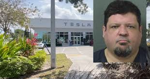 Man arrested for driving into protesters at Tesla dealership
