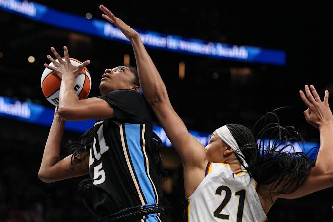 Angel Reese driving toward the rim during intense game action, do AI tạo