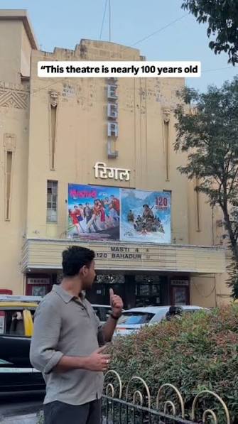 Standing outside Regal Cinema, Colaba — the theatre that changed Mumbai’s movie culture forever., Built in 1933, Regal was one of India’s first Art Deco theatres with full air-conditioning, an ...