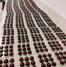 Working Hard At The Feve Chocolate Factory Almost Ready For Delivery Artisan Chocolate Chocolate Covered Nuts Gourmet Chocolate