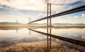 …of the city, by the 25th of april bridge. 25 De Abril Bridge In Lisbon Portugal Fine Art Photography By Nico Trinkhaus