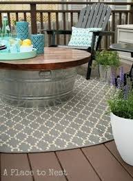 These free diy outdoor table plans will show you how to build a table that you can enjoy all year round. A Bucket Table Provides A Storage Space For Things You Don T Want To Leave Out In The Rain Like Citronella Candles And Pillows Easy Backyard Diy Outdoor Coffee Tables Easy Backyard